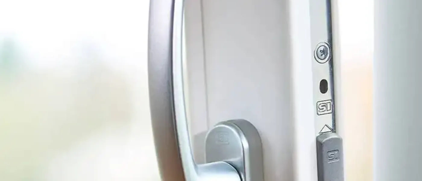 Close-up of door roller wheels being replaced on a sliding patio door track in a British home